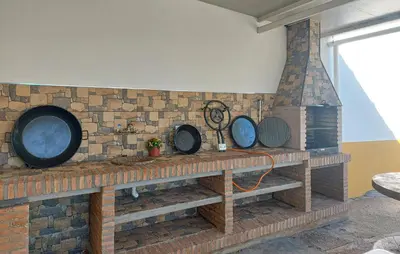 a brick wall with four round pans on a counter at Awesome Home In San José Del Valle in San Jose del Valle