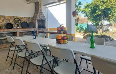 two tables and chairs with bottles and fruit on them at Awesome Home In San José Del Valle in San Jose del Valle