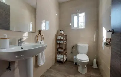 a bathroom with a sink and a toilet at Awesome Home In San José Del Valle in San Jose del Valle