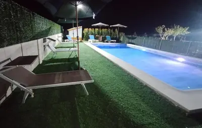 a swimming pool at night with a bench next to it at Awesome Home In San José Del Valle in San Jose del Valle