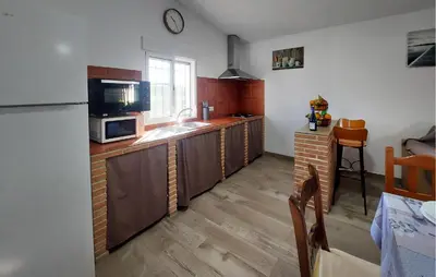 a kitchen with a sink and a microwave at Awesome Home In San José Del Valle in San Jose del Valle