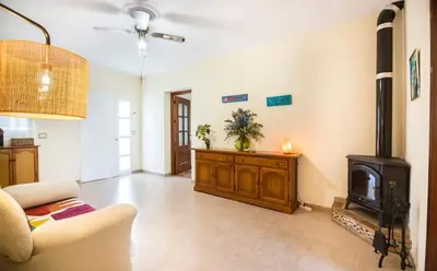 a living room with a couch and a wood stove at Hogar Lowill in Chiclana de la Frontera