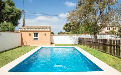 a swimming pool in the yard of a house at Hogar Lowill in Chiclana de la Frontera