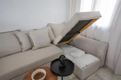 a living room with a couch and a table at Charming Apartment with Private Terrace in Sanlúcar de Barrameda
