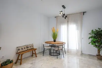 a dining room with a table and chairs at Charming Apartment with Private Terrace in Sanlúcar de Barrameda