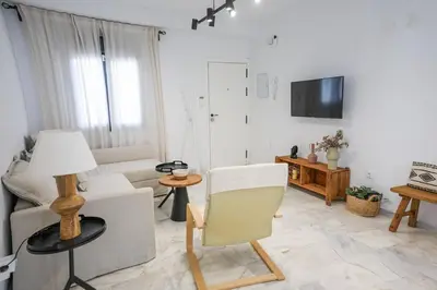 a living room with a couch and a chair at Charming Apartment with Private Terrace in Sanlúcar de Barrameda