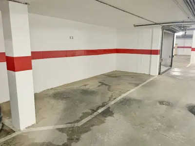 an empty garage with red and white stripes on the walls at El Arrecife - Apartamento a 2 minutos de la playa en El Puerto de Santa María in El Puerto de Santa María