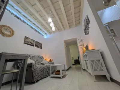 a living room with a couch and a table at La Casita de Cai in Cádiz
