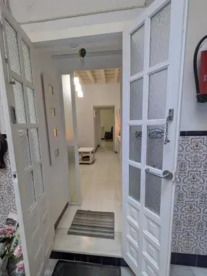 a hallway with white doors and a hallway with a hallway at La Casita de Cai in Cádiz