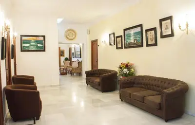 a living room with two couches and two chairs at HOTEL Guadalupe in Chipiona