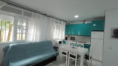 a kitchen with a bed and a table in a room at Apartamento en La Barrosa, Chiclana de la Frontera in Novo Sancti Petri