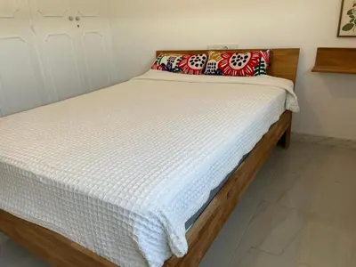 a bed in a bedroom with a white mattress at Paseo Marítimo 8 Cádiz in Cádiz