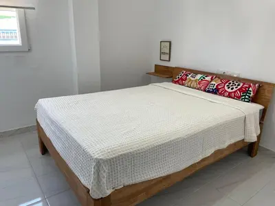 a bed in a white room with at Paseo Marítimo 8 Cádiz in Cádiz