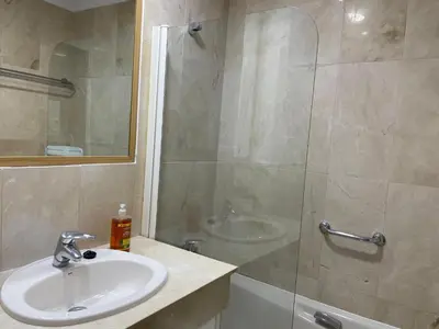 a bathroom with a sink and a shower at Paseo Marítimo 8 Cádiz in Cádiz
