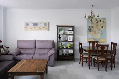 a living room with a couch and a table at Apartamento 3 dormitorios con garaje y wifi gratis a pocos minutos del centro de Jerez in Jerez de la Frontera