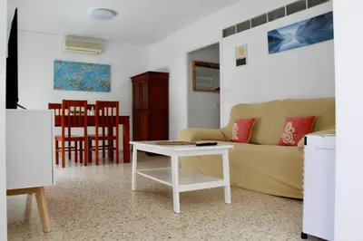 a pair of towels on a bed with a pillow at Feel Beach Apartamento del Mar in El Puerto de Santa María