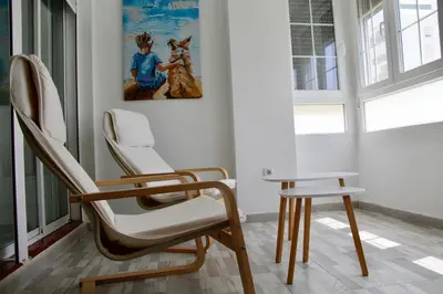 a bathroom with a white toilet and a shower at Feel Beach Apartamento del Mar in El Puerto de Santa María
