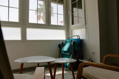 a bedroom with a bed and a air conditioner on the wall at Feel Beach Apartamento del Mar in El Puerto de Santa María