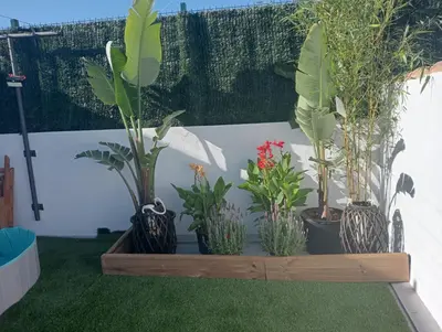 a row of potted plants in a wooden box at El Refugio de MELKART in San Fernando