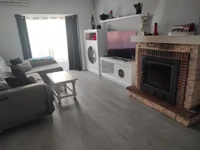 a living room with a couch and a fireplace at El Refugio de MELKART in San Fernando