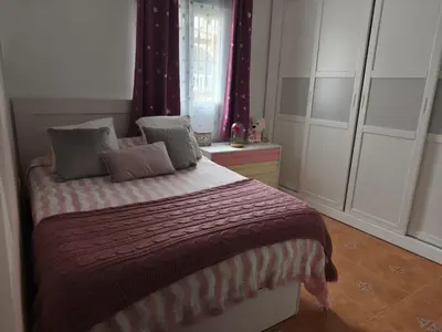a bedroom with a bed with pillows on it at El Refugio de MELKART in San Fernando
