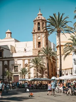 a large building with a clock tower in a city at Hidden Gem CADIZ BEACH LOFT by Apartmentsincadiz in Cádiz