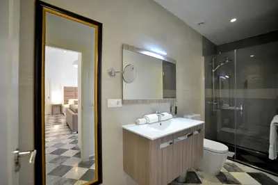 a bathroom with a sink and a shower and a toilet at El Armador Casa Palacio by Luxury Suites Cádiz in Cádiz