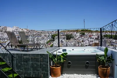 a hot tub on the roof of a house at Hotel Posada de las Cuevas in Arcos de la Frontera