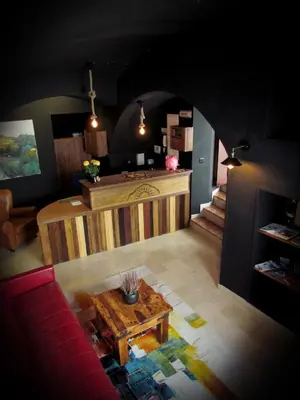 a living room with a table in the middle of a room at Hotel Posada de las Cuevas in Arcos de la Frontera