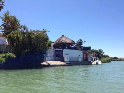 a house on a island in the water at Espectacular casa con embarcadero. in Arcos de la Frontera