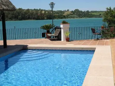 a swimming pool with a view of the water at Espectacular casa con embarcadero. in Arcos de la Frontera