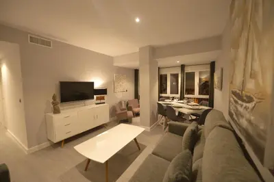 a living room with a couch and a tv and a table at Apartamento Victoria in Cádiz