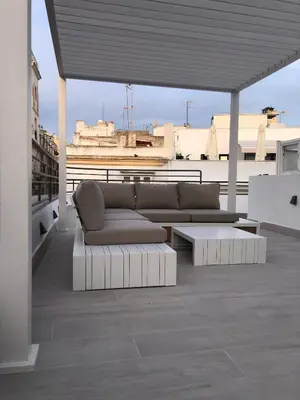 a couch sitting on top of a roof at Apartamentos GADIR CENTRO in Cádiz