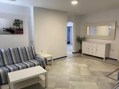 a living room with a couch and a table at Apartamento Medina Puerto Sherry in El Puerto de Santa María
