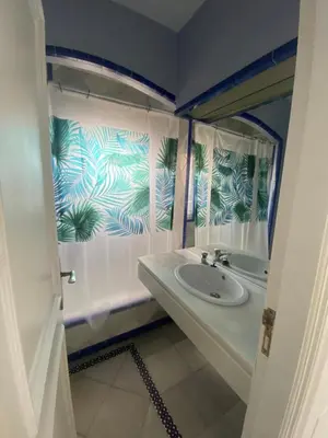 a bathroom with a sink and a mirror at Apartamento Medina Puerto Sherry in El Puerto de Santa María