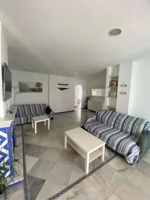 a living room with a couch and a table at Apartamento Medina Puerto Sherry in El Puerto de Santa María