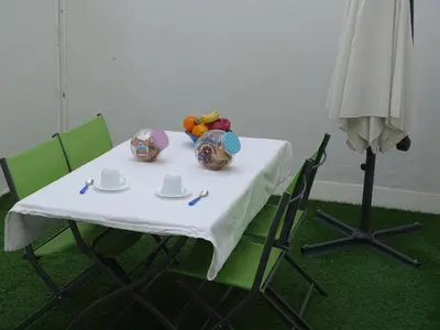 a table with a white table cloth on it with chairs at Apartamento Oropendola 9 in El Puerto de Santa María