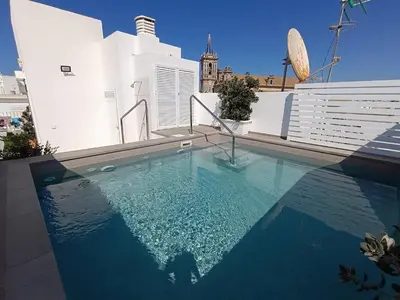 a swimming pool on the roof of a building at Villablanca Apartamento in Chipiona