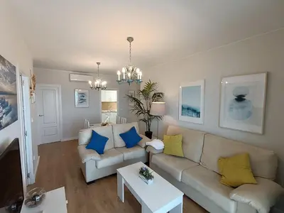 a living room with a couch and a table at Villablanca Apartamento in Chipiona