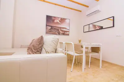 a living room with a couch and a table at Apartamentos Centro Puerto de Santa Maria in El Puerto de Santa María