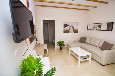a living room with a couch and a flat screen tv at Apartamentos Centro Puerto de Santa Maria in El Puerto de Santa María