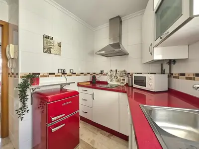 a kitchen with a red refrigerator and a sink at Studio Novena Little Apartments in Cádiz