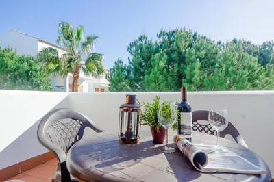 a table with a bottle of wine and two glasses at Maracaibo in Chiclana de la Frontera