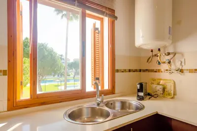 a sink in a kitchen with a window at Maracaibo in Chiclana de la Frontera