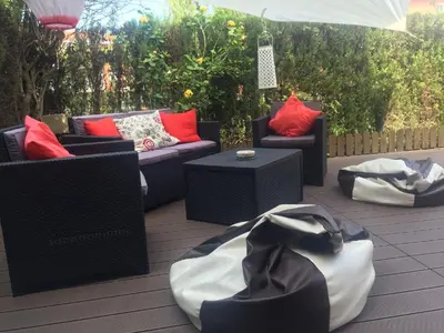 a patio with couches and chairs and a table at Divi Apartments Costa Ballena in Costa Ballena