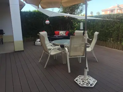 a patio with a table and chairs and an umbrella at Divi Apartments Costa Ballena in Costa Ballena