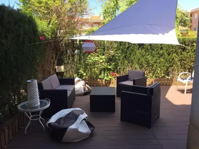 a patio with chairs and a table and an umbrella at Divi Apartments Costa Ballena in Costa Ballena