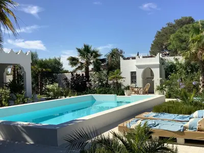 a swimming pool in front of a villa at Kasbah Andaluz guest house in Chiclana de la Frontera