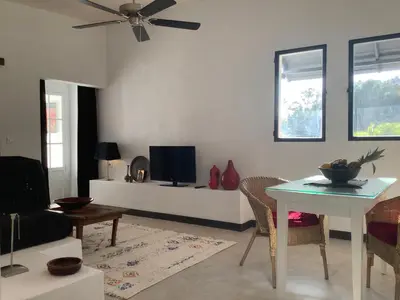 a living room with a table and a tv at Kasbah Andaluz guest house in Chiclana de la Frontera