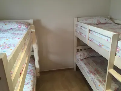 two bunk beds in a small room at Cadiz Deluxe Apartment in Cádiz